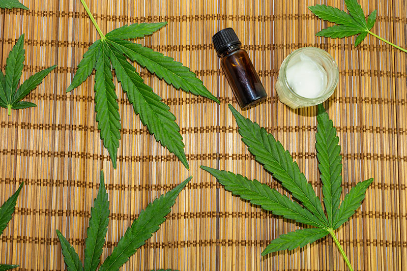 broad spectrum cbd products with hemp leaves on the background