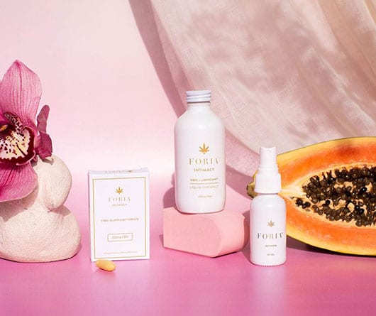 foria products with papaya and flower on the side