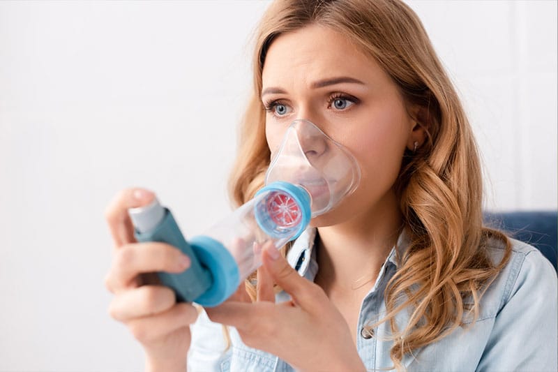 woman having an inhaler