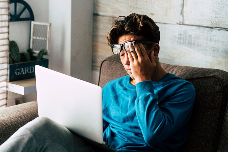 man having fatigue while doing computer works
