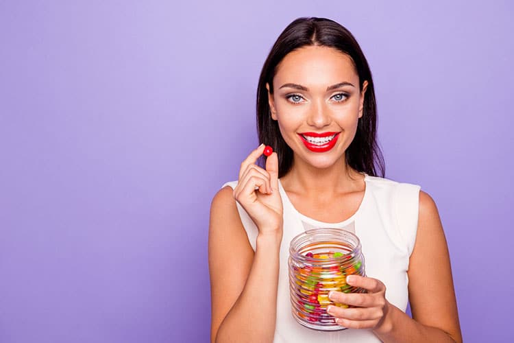 woman happily eating cbd gummies