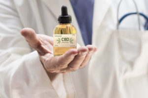 a doctors hand with cbd oil